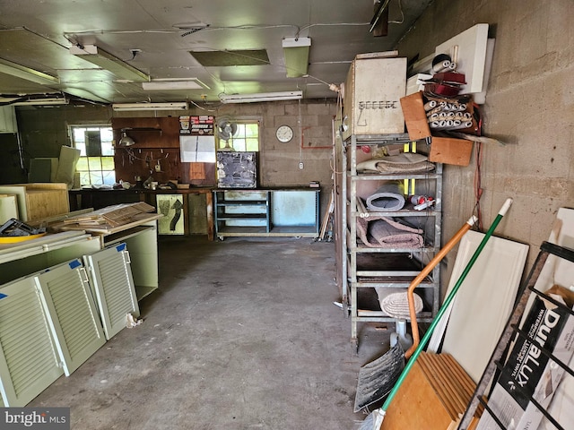 interior space with plenty of natural light, a workshop area, and concrete floors