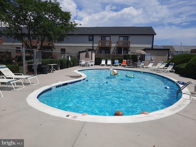 pool featuring a patio and fence