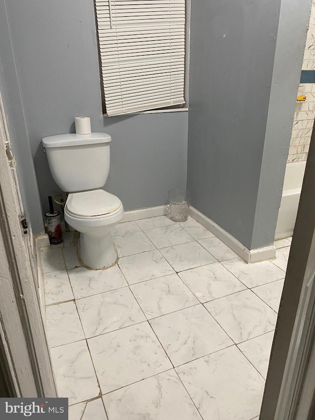 bathroom with a tub and toilet