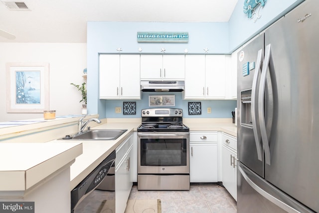 kitchen featuring stainless steel appliances, sink, light tile patterned floors, and white cabinets