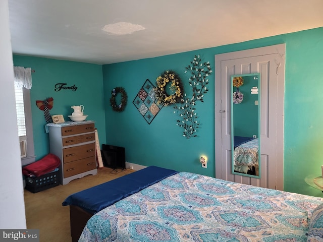 bedroom featuring light colored carpet