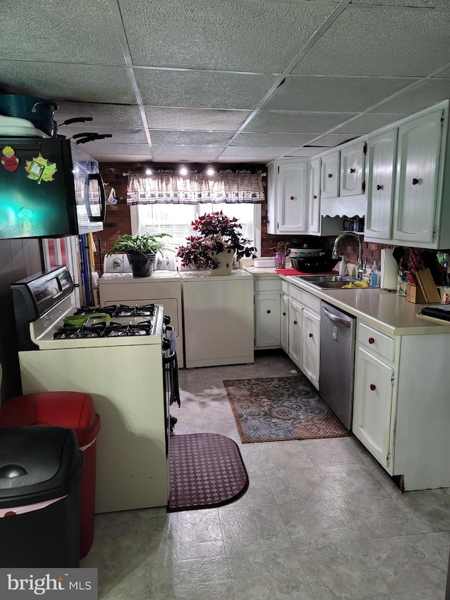 kitchen featuring white cabinetry, stainless steel dishwasher, washer / dryer, and sink