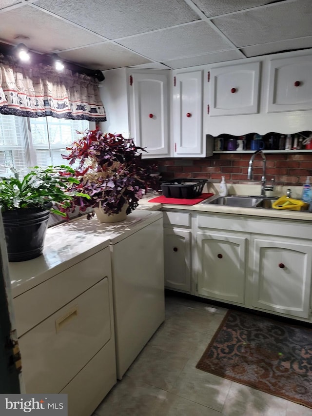 washroom featuring cabinets, washing machine and dryer, and sink