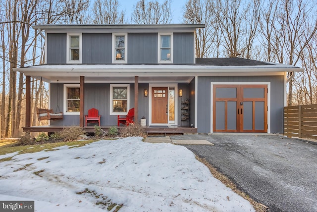 view of front property featuring a garage and covered porch