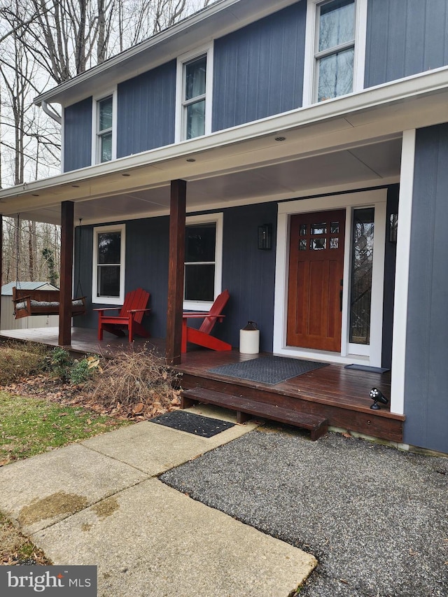 property entrance with covered porch