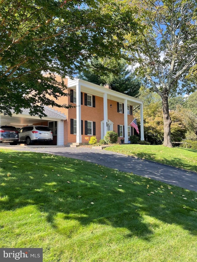 neoclassical home with a front lawn