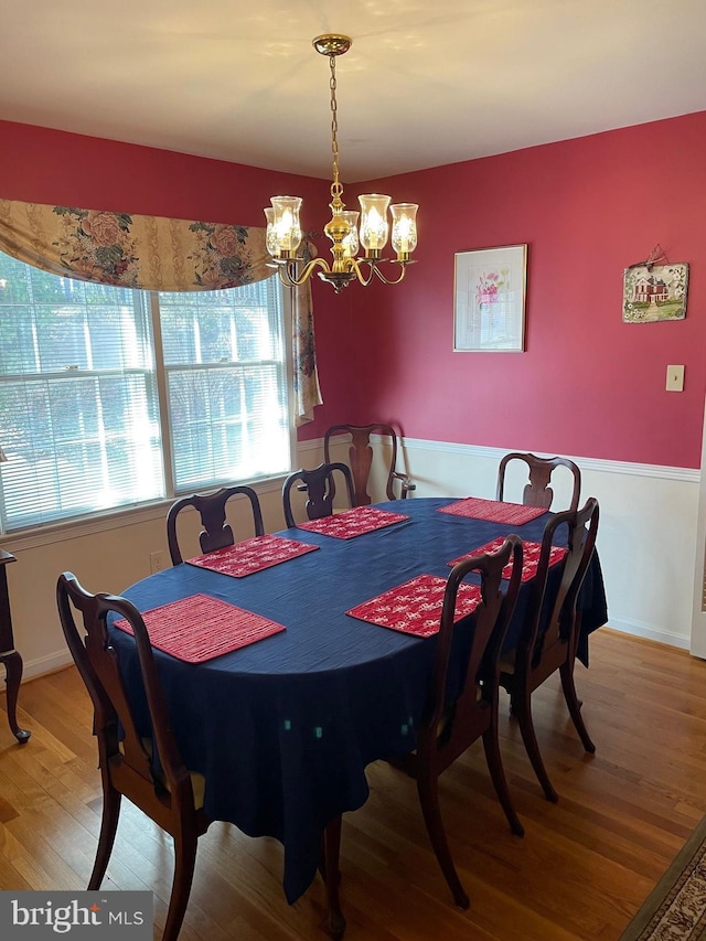 dining space with an inviting chandelier and wood-type flooring