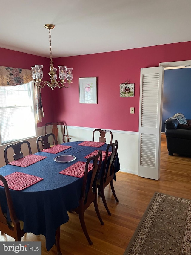 dining room featuring hardwood / wood-style flooring and a chandelier