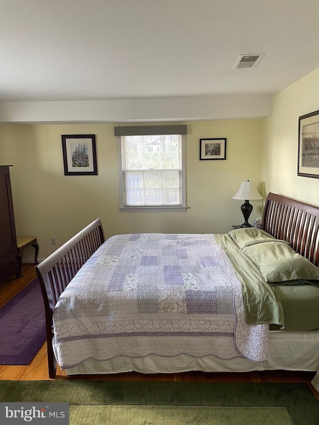 bedroom with hardwood / wood-style flooring