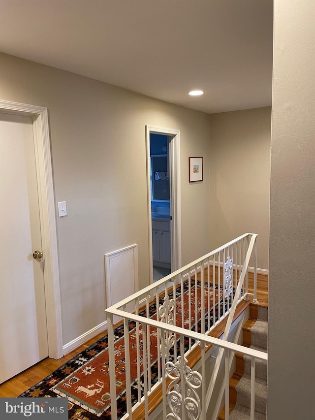 staircase with hardwood / wood-style flooring