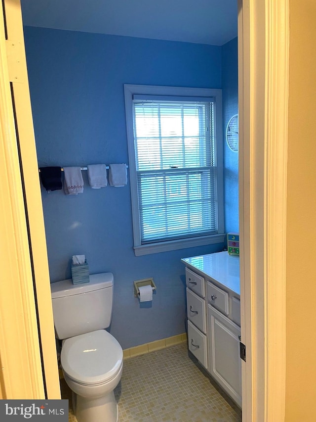 bathroom featuring vanity, toilet, and tile patterned flooring