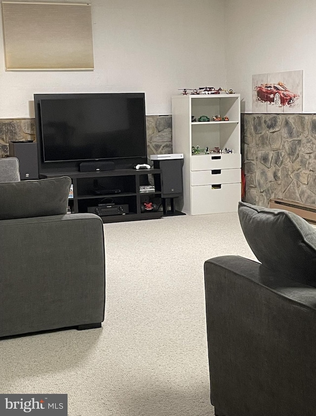 carpeted living room featuring baseboard heating