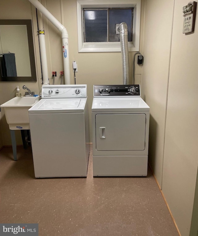 washroom featuring separate washer and dryer and sink