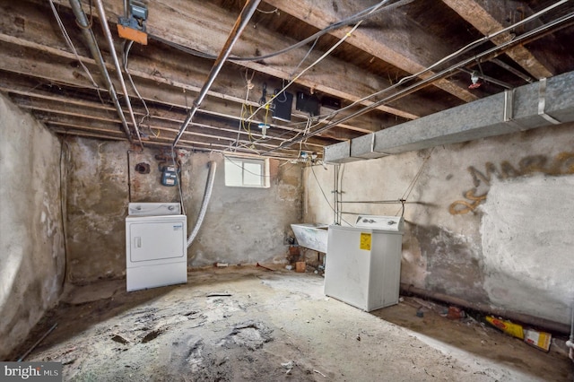 basement with sink and washer and clothes dryer