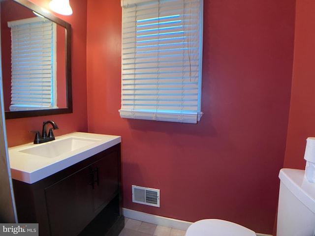 bathroom featuring vanity and toilet