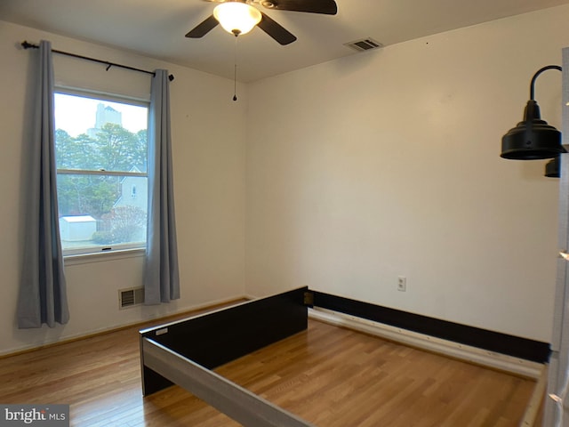 unfurnished bedroom featuring light hardwood / wood-style flooring and ceiling fan