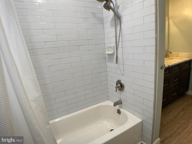 bathroom featuring sink, hardwood / wood-style floors, and shower / bath combo with shower curtain