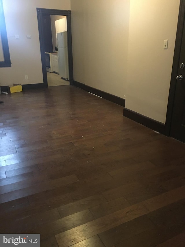 unfurnished room featuring dark wood-type flooring