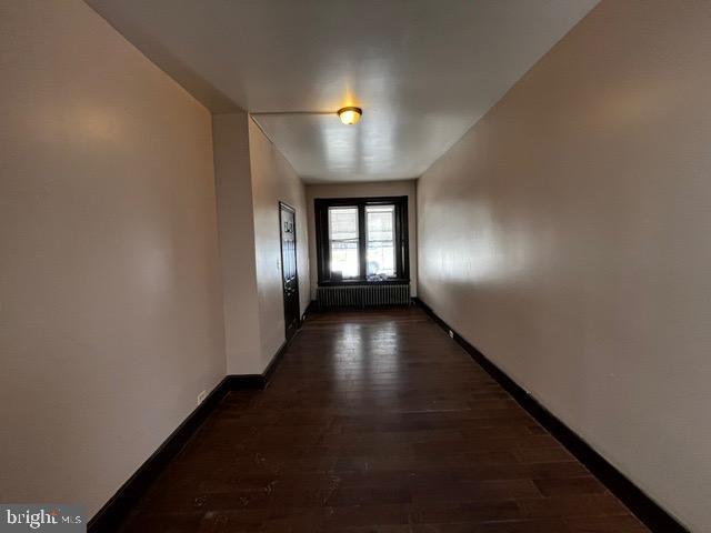 entryway featuring radiator heating unit and dark hardwood / wood-style floors