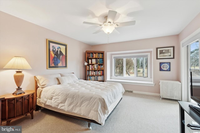 bedroom with ceiling fan, carpet flooring, and radiator