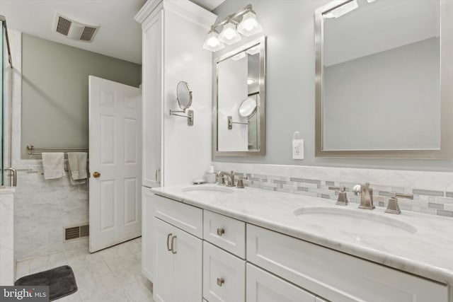 bathroom with vanity, a shower with door, and tile walls