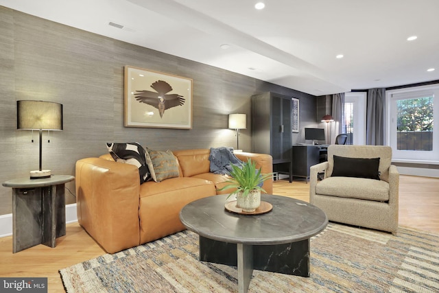 living room featuring wallpapered walls, wood finished floors, visible vents, and recessed lighting