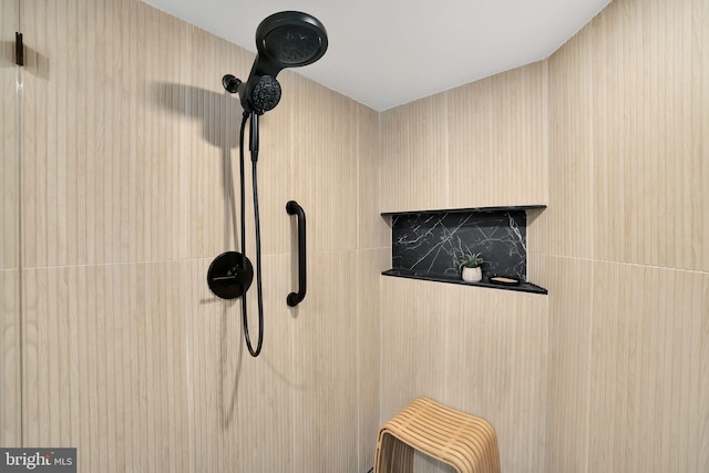 interior details featuring tiled shower