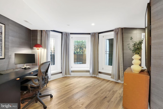 home office featuring visible vents and wood finished floors