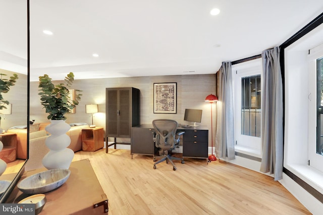 office with wood finished floors and recessed lighting