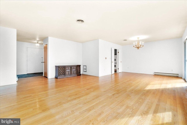 unfurnished living room featuring a baseboard heating unit, light wood-type flooring, visible vents, and an inviting chandelier