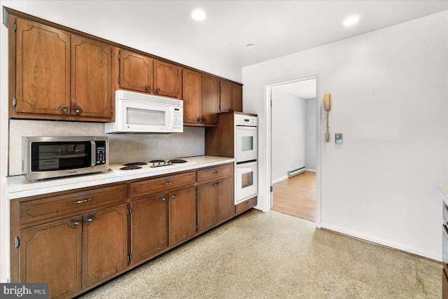 kitchen featuring light floors, a baseboard radiator, light countertops, backsplash, and white appliances