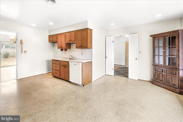 kitchen featuring white dishwasher, a baseboard heating unit, a sink, light countertops, and brown cabinets