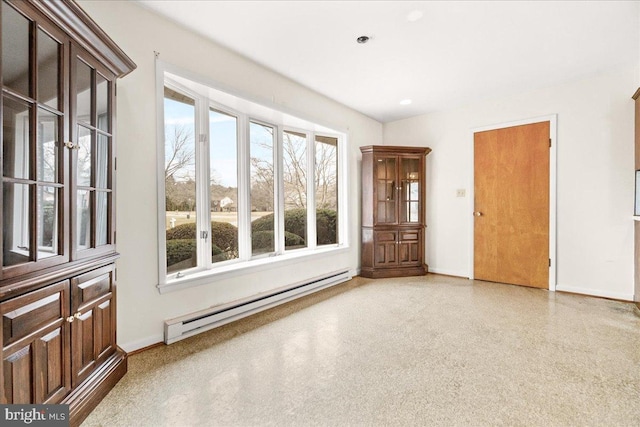 empty room featuring baseboards and baseboard heating