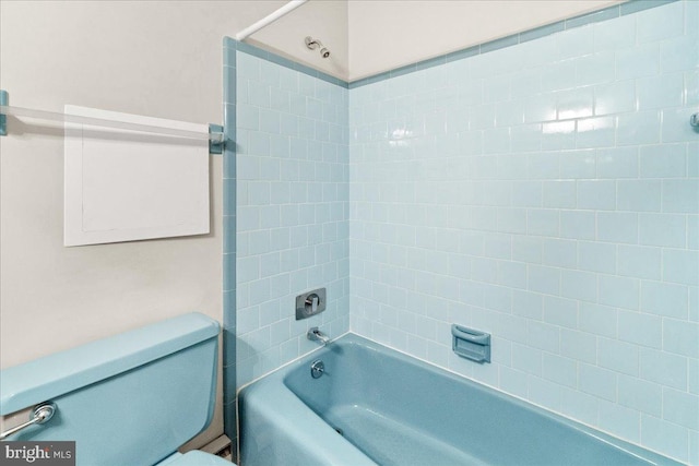 bathroom featuring shower / bathtub combination and toilet