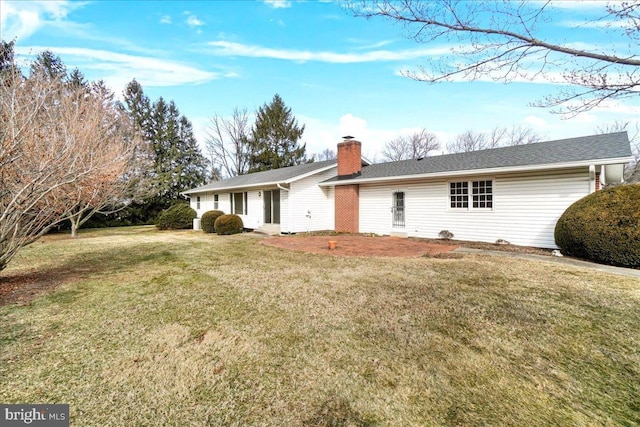 view of front of property with a front lawn and a chimney