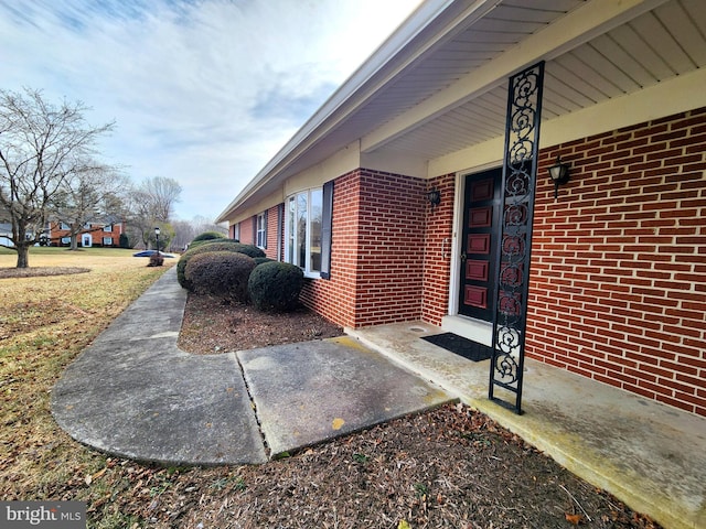 entrance to property with brick siding