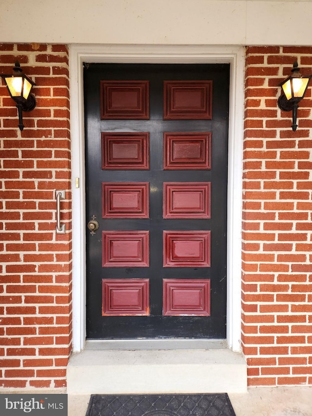 entrance to property with brick siding