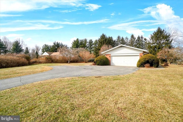 exterior space with aphalt driveway and an attached garage