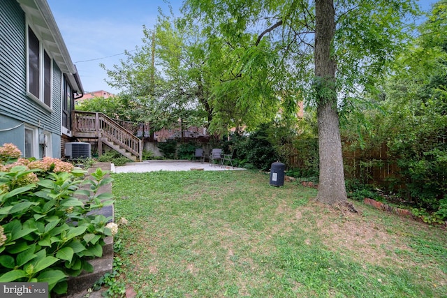 view of yard featuring central AC unit and a patio