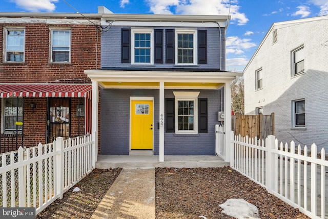 townhome / multi-family property with covered porch