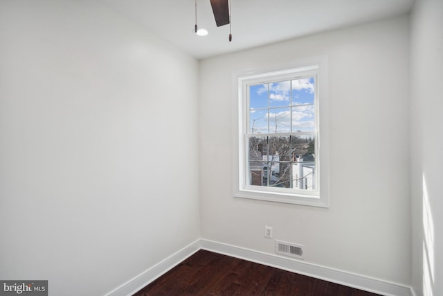 unfurnished room featuring dark hardwood / wood-style floors and ceiling fan