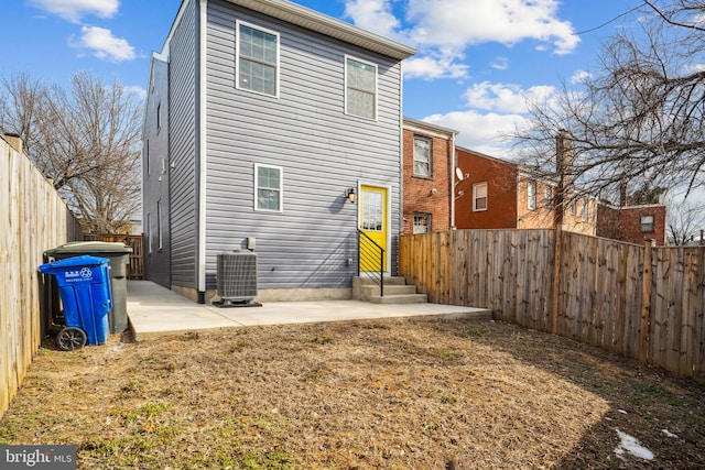 rear view of house with cooling unit and a patio