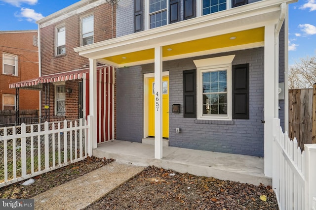 entrance to property featuring a porch