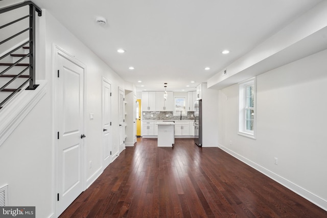 unfurnished living room featuring dark hardwood / wood-style flooring