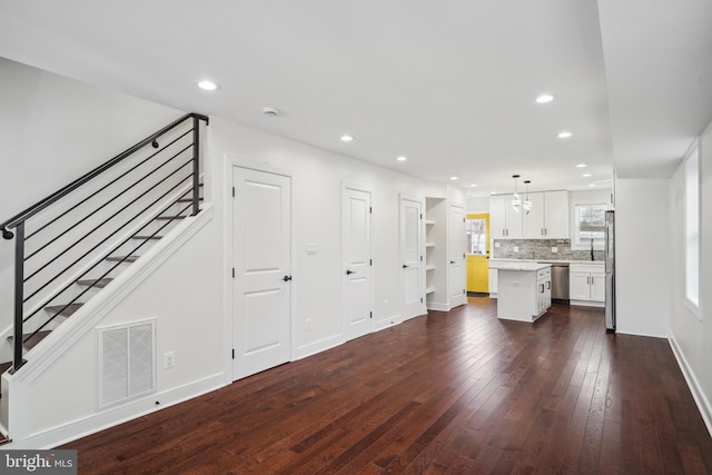 unfurnished living room with dark hardwood / wood-style floors