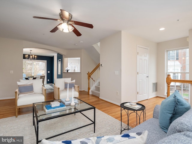 living room with a notable chandelier and light hardwood / wood-style flooring