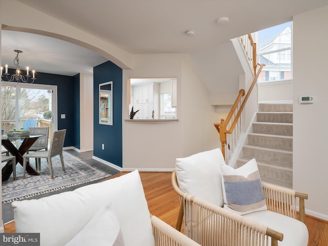 interior space featuring hardwood / wood-style flooring and an inviting chandelier