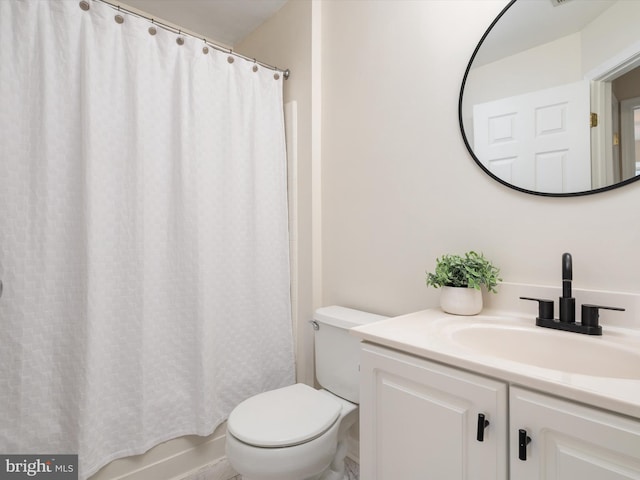 bathroom featuring vanity, curtained shower, and toilet