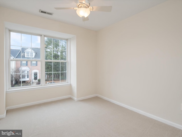 carpeted empty room with ceiling fan