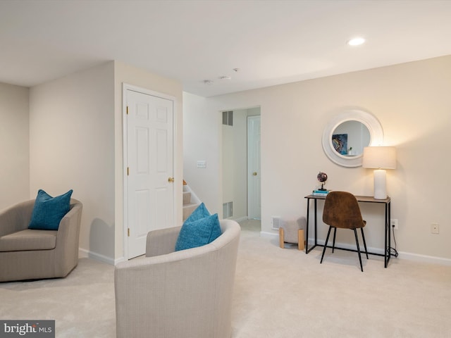 sitting room featuring light carpet